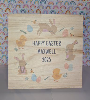 A wooden box with Easter images encircling the personalised area, which reads "Happy Easter Maxwell 2025"