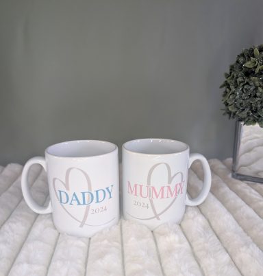 Pair of mugs. One with Mummy, a heart, and a year. One with Daddy, a heart, and a year